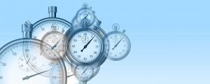 Clocks floating against a blue background to symbolize nonprofit project management