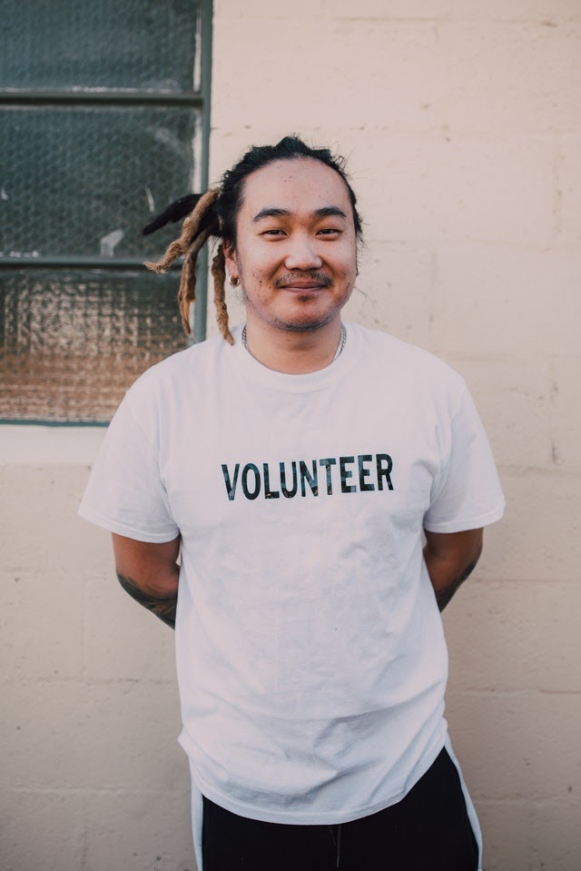 A volunteer standing at a fundraising event.