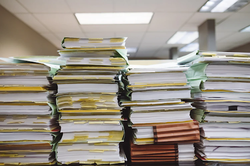 A photo of the stacks of paperwork for multi-state nonprofit registration