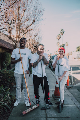 A photo of three volunteers cleaning at a nonprofit event