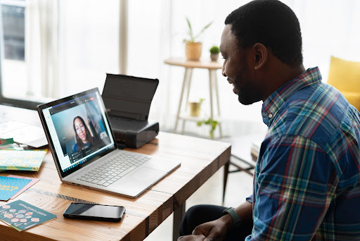 A man on a video conferencing call at work with a colleague at a nonprofit