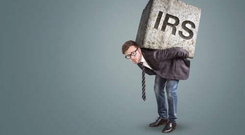 Man carrying IRS block on his back