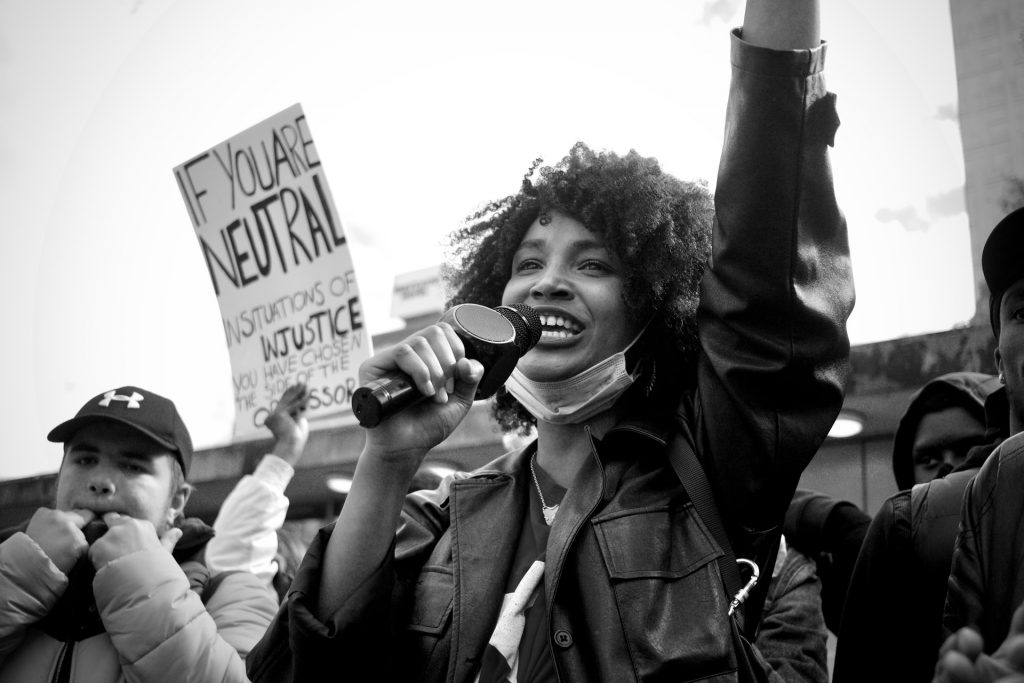 Image of a black woman smiling at a social justice event with the ACLU, an example of 501(c)(4) nonprofit.