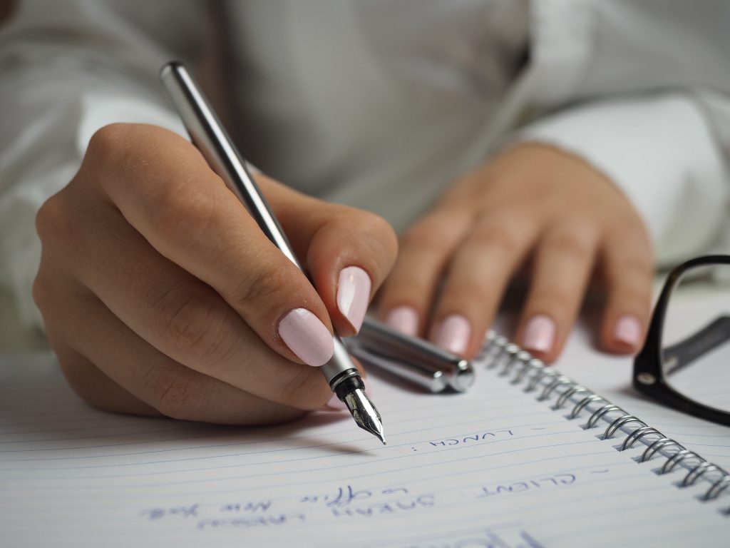 A member of a board of directors writes in a notebook