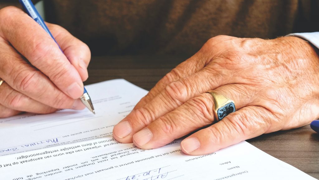 Photo of a board member signing nonprofit bylaws documents.